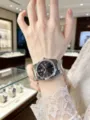 Detail view of men's steel strap quartz watch with dark dial, elegant and sleek design. - White Steel Black