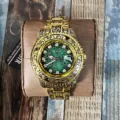 Elegante goldene Quarz-Herrenuhr mit grünem Zifferblatt, Datumsanzeige und Stahlarmband. - Gold und Stahl Grünes Zifferblatt