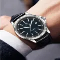Men's luxury business watch with black textured dial, rhinestone markers, and leather strap. - Black Leather Strap Silver Case Black Mother-of-Pearl Dial