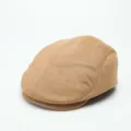 Close-up view of a brown suede flat cap showing fine texture and neat stitching details. - One Size / Camel