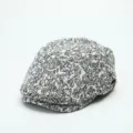 Detailed view of the vintage black and white floral patterned flat cap, ivy beret texture. - M (56-58cm) / White
