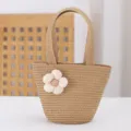 Detailed view of the cute straw woven handbag featuring a white fabric flower, perfect for beach. - 17x14x6.5 / Khaki
