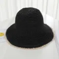 Detailed shot of black woven straw bucket hat with delicate beige lace trim for summer beach. - M (56-58cm) / Black