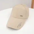 Classic beige baseball cap with extended brim and stylish metal sport logo for outdoor wear. - Adjustable / Khaki