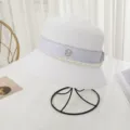 White straw bucket hat with pearl chain and M rhinestone logo, elegant summer sun hat. - M (56-58cm) / White