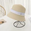 Elegant summer straw bucket hat for women, featuring white ribbon, pearls and crystal M logo. - M (56-58cm) / Beige
