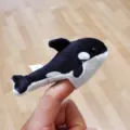 Detailed view of cute killer whale plush finger puppet, soft fabric, ideal interactive toy. - Whale Finger Puppet