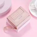 Pink short wallet for women, stylish checkered fold design with zipper pocket and wrist strap. - Pink