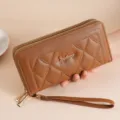 Brown long quilted women wallet featuring double zippers and practical wrist strap. - Coffee