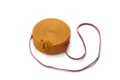 Detailed view of a round rattan woven crossbody bag with long strap and natural texture. - Yellow