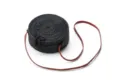 Detailed view of black round woven rattan shoulder bag with adjustable brown leather strap. - Black