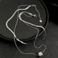 Detailed shot of double-layer titanium steel snake bone chain necklace with a square pendant. - Double Layer Cube Necklace