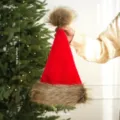Red Christmas hat with brown plush trim and fluffy pompom, holiday party costume 47cm - Adult / Red Brown