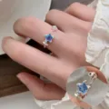 Stylish silver open ring featuring blue crystal stone, adjustable chic finger jewelry design. - Open Adjustable / Blue Star