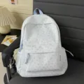 Cute floral fabric backpack for women students, stylish casual school bag with front pocket. - Blue
