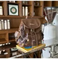 Vintage brown leather backpack for women, casual school bookbag with cute dog charm and pockets. - Brown + Chocolate Puppy