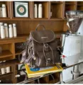 Vintage brown leather backpack for women, stylish college style commuting schoolbag with cute charm. - Coffee + Chocolate Puppy