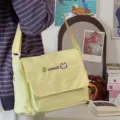 Detailed view of the cute yellow canvas messenger bag with embroidery, perfect for students. - Single Bag (Without Charm) / Yellow