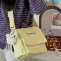Detailed view of cute Japanese ins style canvas messenger bag with fluffy bear charm. - With Charm / Yellow