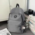 Minimalist grey nylon school backpack for students with stylish front logo and cute daily bag. - Gray