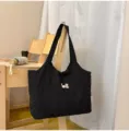 Black canvas tote bag with cute dog embroidery, minimalist casual commuting crossbody bag. - Black