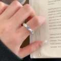 Sweet minimalist heart flower ring for women, sterling silver open finger ring with blue crystal detail. - Adjustable / Blue Gem Brushed Ring (JZ7913)