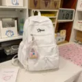 White embossed backpack with front pockets and cute charm for students daily use. - With Charm / L / White