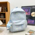 Ice blue star pattern school backpack with cute plush pendant, casual student commuter bag. - Blue & Blue Stars with Pompoms