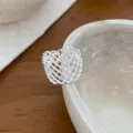 Close-up detail of silver geometric mesh open ring beautifully displayed on stone tray. - Open Adjustable / Hollow Mesh Geometric Style (JZ5051)
