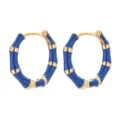 Close-up detail of blue and gold bamboo hoop earrings showing exquisite craftsmanship and texture. - Blue