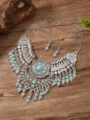Close-up details of vintage bohemian turquoise necklace and earrings set with silver filigree. - Antique Silver Blue