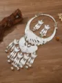Detailed shot of ethnic Miao silver peacock necklace and tassel earrings set with bells. - Silver