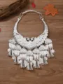 Detailed view of traditional Miao style silver peacock collar necklace with bells and charms. - Silver