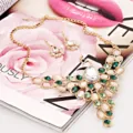 Exquisite peacock necklace and earrings jewelry set detail shot, featuring sparkling rhinestones. - Green