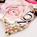 Detailed close-up shot of exquisite peacock rhinestone necklace and earrings set. - Colorful