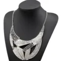 Detailed view of vintage punk style geometric cutout layered necklace statement jewelry. - Antique Silver