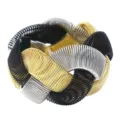 Chunky interwoven metallic spring bracelet in black gold and silver, detailed texture. - Black Gold Silver