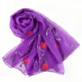 Purple chiffon scarf detail showing exquisite red flower and green vine embroidery patterns. - Purple