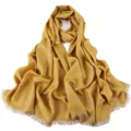 Gold glitter polka dot detail on yellow fabric of long scarf fringe edge close-up - 08