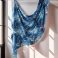 Blue marble print scarf detail shot, showing soft draping texture and elegant light shadows. - Black and Red (02)