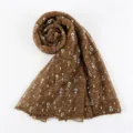 Detailed close-up of the pleated brown women's metallic sequin scarf texture and colorful dots. - Coffee