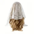 White lace chapel veil mantilla featuring delicate Virgin Mary embroidery and scalloped lace edge. - White
