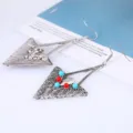 Detailed view of vintage alloy triangle earrings featuring red and blue beads for women. - Antique Silver