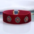 Detailed view of red velvet choker necklace with vintage gemstone ornate metal centerpiece for women. - Red with Antique Silver Rhinestone Style