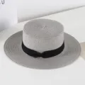 Detailed view of women flat top straw hat with black ribbon bow, vintage summer sun hat. - M (56-58cm) / Gray