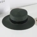 Detailed view of the dark green flat top straw hat with elegant black bow ribbon. - M (56-58cm) / Dark Green
