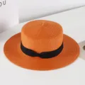 Orange straw boater hat with black bow, stylish summer sun protection beach hat detail. - M (56-58cm) / Orange