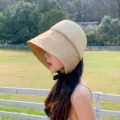 Detailed shot of a stylish women color block sun hat with wide brim and black ribbon tie for summer. - M (56-58cm) / Khaki