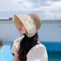 Close-up of summer colorblock sun hat with straw crown, wide brim and rhinestone logo. - M (56-58cm) / Beige