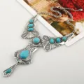 Retro boho statement ketting met turkoois stenen en zilverkleurig metalen design. - Blauw